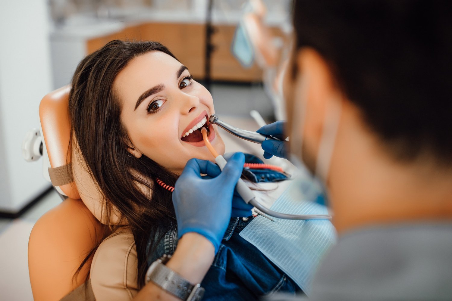 young-female-patient-visiting-dentist-office.jpg